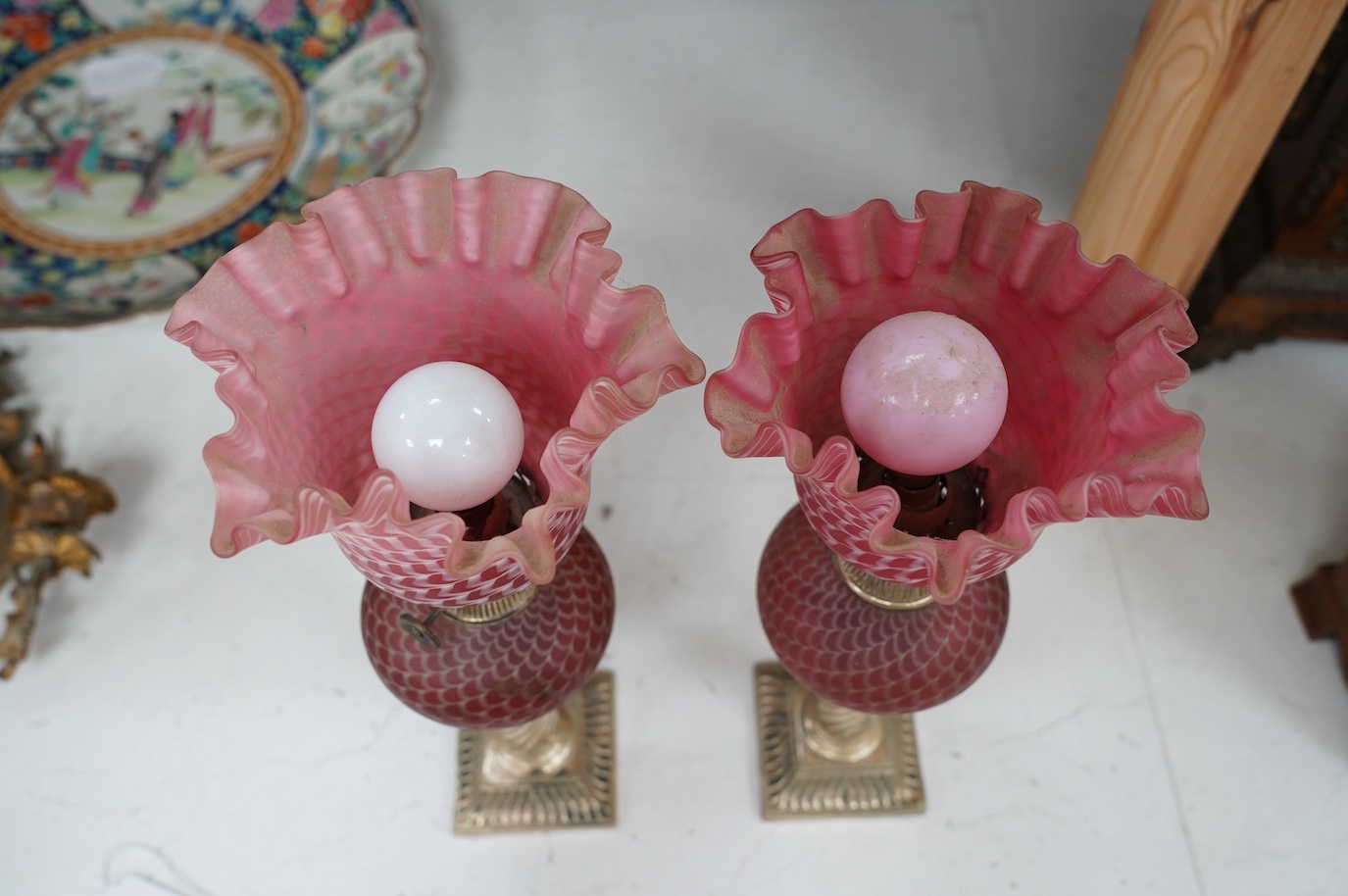 A pair of electroplate and ruby glass oil lamps, 35cm. Condition - good, not tested as working